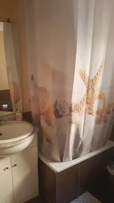 a bathroom with a sink and a shower curtain at Relaxed Space in the beach in Puerto de Sagunto