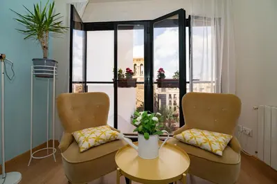 two beds in a room with white walls and blue pillows at La Seda Stay in Valencia