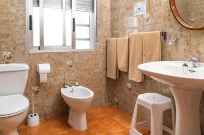 a bathroom with a sink and a toilet and a mirror at Hotel Borja in El Puig