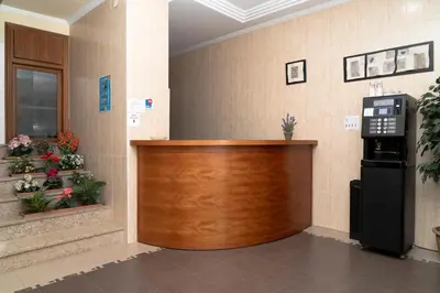 a lobby with a wooden reception counter in a building at Hotel Borja in El Puig