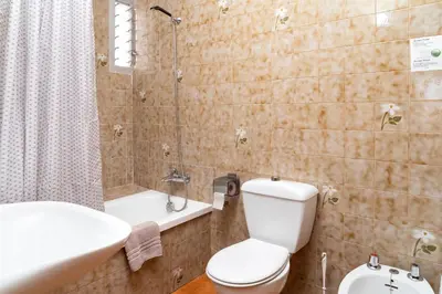 a bathroom with a toilet and a sink and a shower at Hotel Borja in El Puig