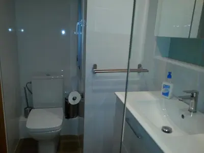 a white bathroom with a toilet and a sink at Edificio Tiziano Mercado Central in Valencia