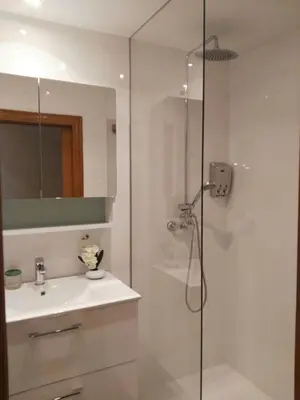 a white bathroom with a shower and a sink at Edificio Tiziano Mercado Central in Valencia