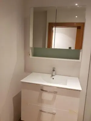 a bathroom with a sink and a mirror at Edificio Tiziano Mercado Central in Valencia