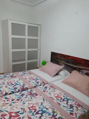 a bedroom with a bed with a blanket on it at Casa Pueblo Alzira No Compartida in Alzira