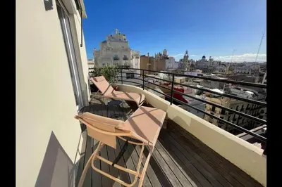 a pair of chairs sitting on a balcony at San Vicente in Valencia