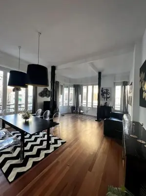 a large living room with a table and a couch at San Vicente in Valencia