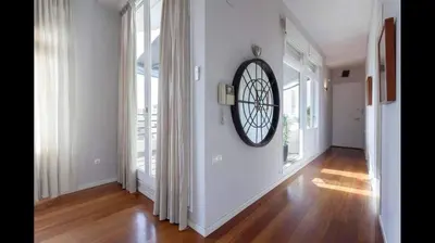 a hallway with a large clock on the wall at San Vicente in Valencia