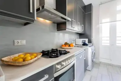 a kitchen with a bowl of fruit on a counter at San Vicente in Valencia