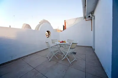 a table and chairs on the balcony of a building at RealRent Marina Real in Valencia