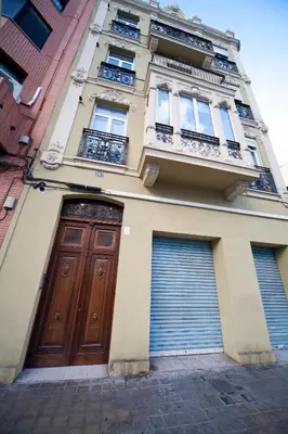 a tall building with two doors and two gates at RealRent Marina Real in Valencia