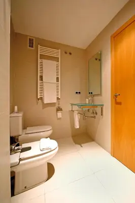 a bathroom with a toilet and a sink at RealRent Marina Real in Valencia