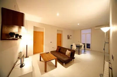 a living room with a couch and a table at RealRent Marina Real in Valencia