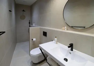 a bathroom with a sink and a toilet and a mirror at VALOLA Boutique Rooms in Valencia