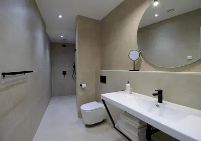 a bathroom with a sink and a toilet and a mirror at VALOLA Boutique Rooms in Valencia