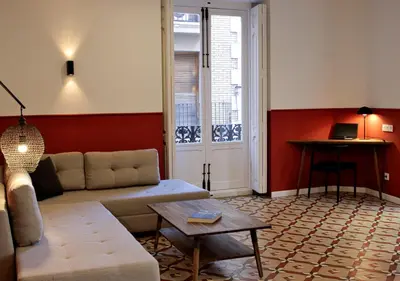 a living room with a couch and a table at VALOLA Boutique Rooms in Valencia