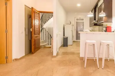a kitchen with a counter and stools in a room at Lovely Apartment! in Valencia