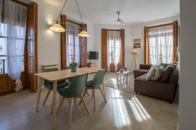 a living room with a table and chairs and a couch at Lovely Apartment! in Valencia