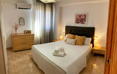 a bedroom with a bed with two towels on it at Travel Habitat Jardines de Viveros in Valencia