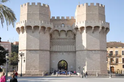 a building with two towers with people standing outside at Travel Habitat Jardines de Viveros in Valencia