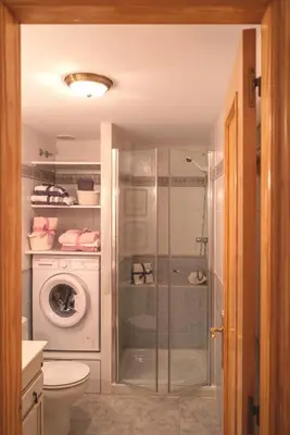 a bathroom with a shower and a washing machine at Avinguda Mare Nostrum, 101 in Moncófar