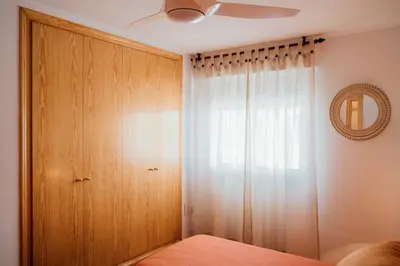 a bedroom with a closet and a ceiling fan at Avinguda Mare Nostrum, 101 in Moncófar