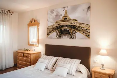 a bedroom with a bed and a picture of the eiffel tower at Avinguda Mare Nostrum, 101 in Moncófar