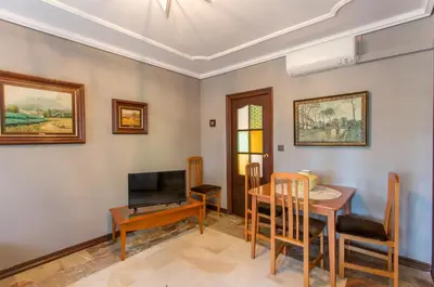 a living room with a table and a television at Apartamentos Gaudi Style in Náquera