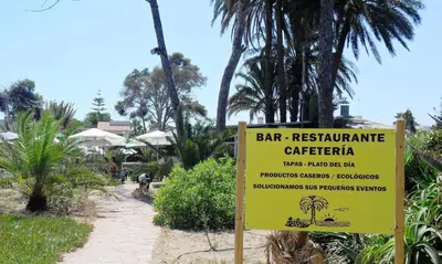 a yellow sign in front of a bar restaurant cafeteria at Apartamentos Concha del Mar in Sagunto