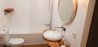 a bathroom with a white sink and a mirror at Domus Valencia Apartamentos centro frente a Torres de Serrano in Valencia