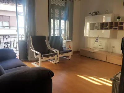 a living room with two chairs and a couch at Apartamento con vistas a la Marina Real in Valencia