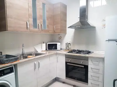 a small kitchen with a stove and a microwave at Apartamento con vistas a la Marina Real in Valencia