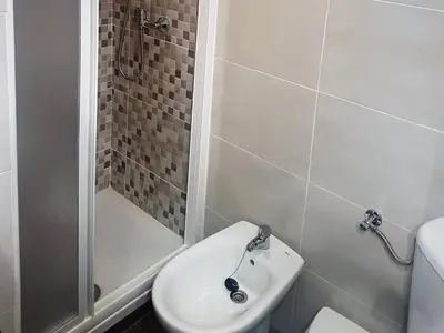 a bathroom with a shower and a toilet and a sink at Apartamento con vistas a la Marina Real in Valencia