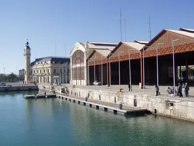 a large building next to a body of water at Apartamento con vistas a la Marina Real in Valencia