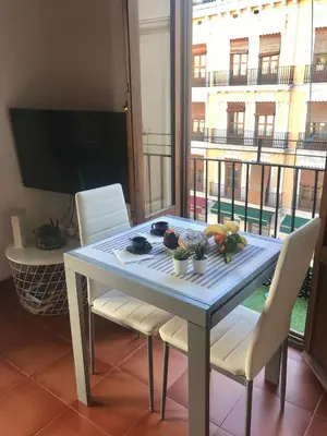 a dining room table with chairs and a view of a building at Cool Central Market in Valencia