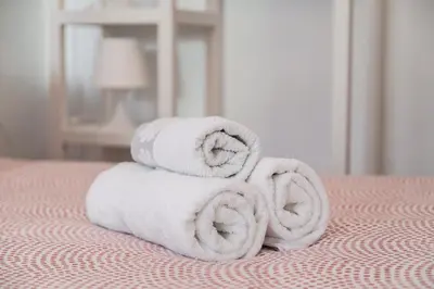 a stack of towels sitting on top of a bed at Cool Central Market in Valencia