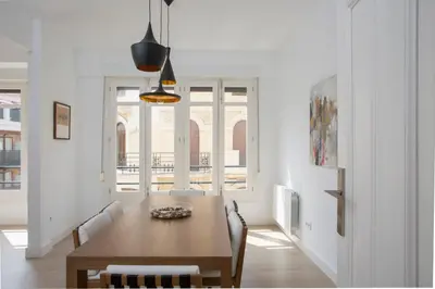 a dining room with a wooden table and chairs at SingularStays Santa Clara in Valencia