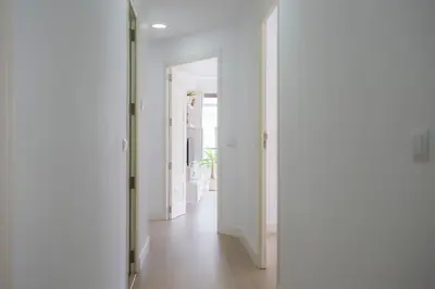 a hallway with white walls and an open door at SingularStays Santa Clara in Valencia