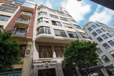 a tall white building with trees in front of it at SingularStays Santa Clara in Valencia