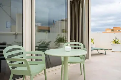 a table and two chairs sitting on a balcony at Teide Rooms in Puerto de Sagunto