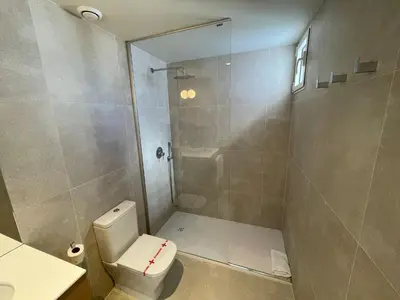 a bathroom with a shower with a toilet and a sink at Teide Rooms in Puerto de Sagunto