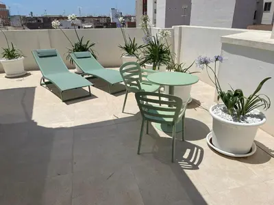 a group of chairs and tables on a roof at Teide Rooms in Puerto de Sagunto