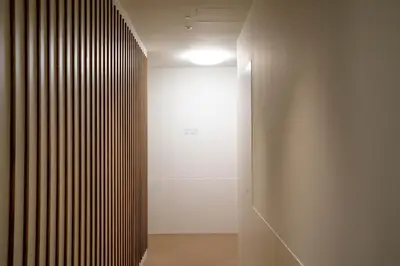 a hallway with a door leading into a white room at Teide Rooms in Puerto de Sagunto