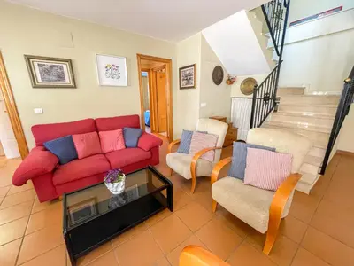 a living room with a red couch and chairs at Apartamentos Canet de Berenguer 3000 in Canet de Berenguer