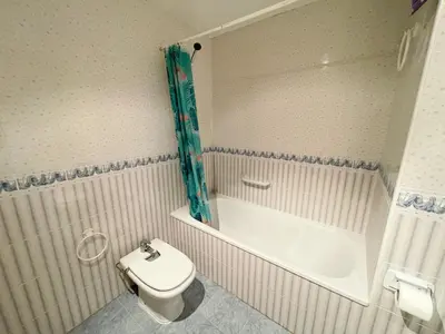 a bathroom with a toilet and a tub and a sink at Apartamentos Canet de Berenguer 3000 in Canet de Berenguer