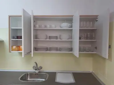 a kitchen with a sink and white cabinets with dishes at Casual House Valencia in Valencia