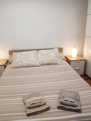 a bedroom with a bed with two towels on it at Casual House Valencia in Valencia