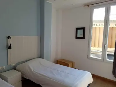 a small bedroom with a bed and a window at Russafa Youth Hostel in Valencia