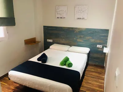 a bedroom with a bed with green pillows on it at Mar & City Apartment in Valencia