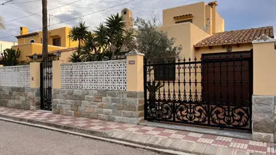 a gate in front of a house at Precioso chalet en la playa de Tavernes de la Valldigna in Tavernes de Valldigna